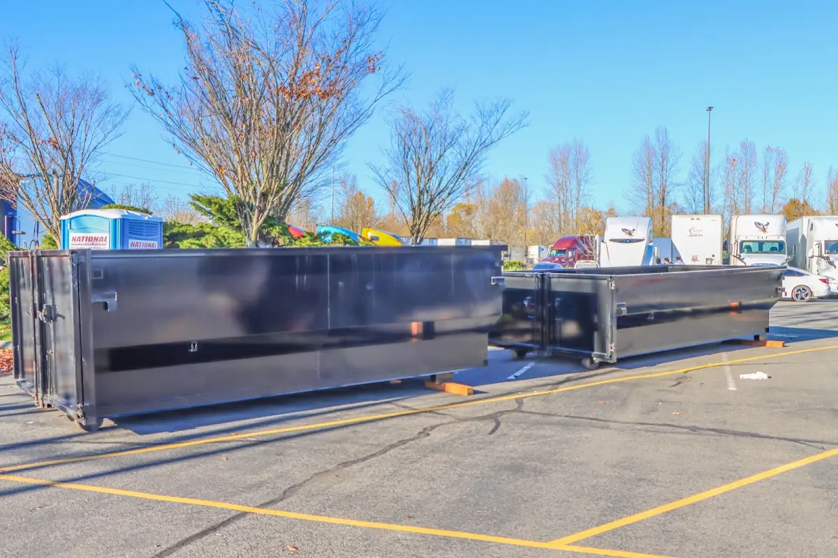 Professional dumpster rental service with roll-off container on residential driveway in Richmond Hill